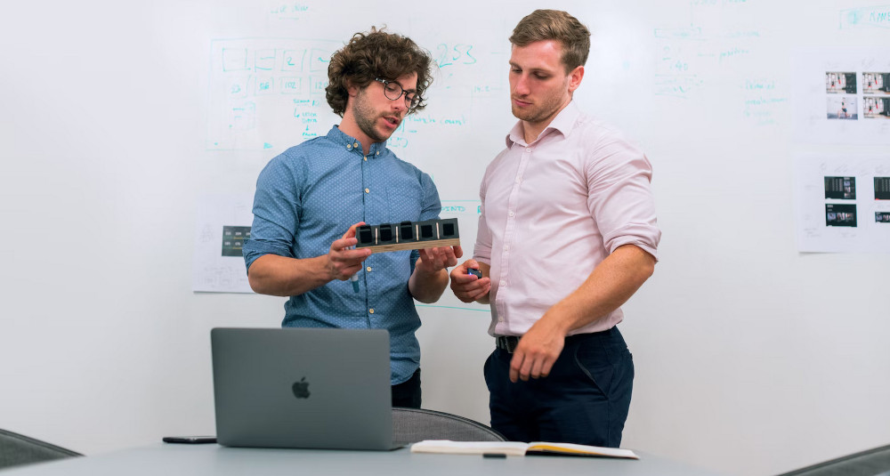 Elearning developer consulting with SME about a product.