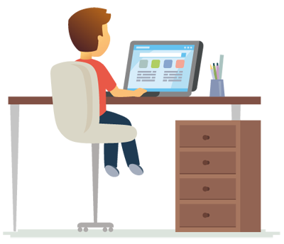 A student sitting while using a laptop on a table. There are also pens on the table and cabinets under it.