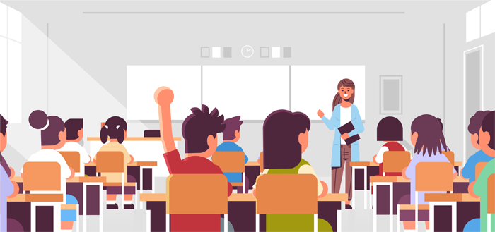 A real traditional classroom showing the teacher and the whiteboard on the far background, with the the back of the students seen in this view. One of the students is raising his hand.